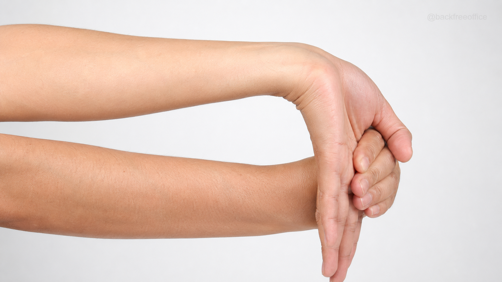 Close-up of a seated wrist flexor stretch with the palm facing upward